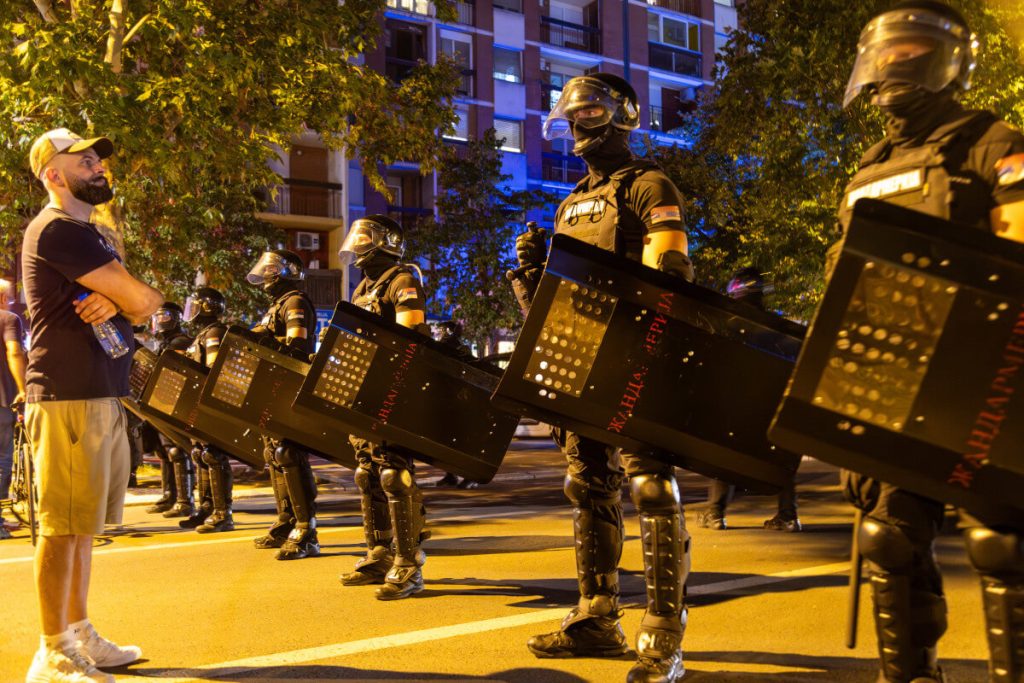 A protester in front of a police cordon